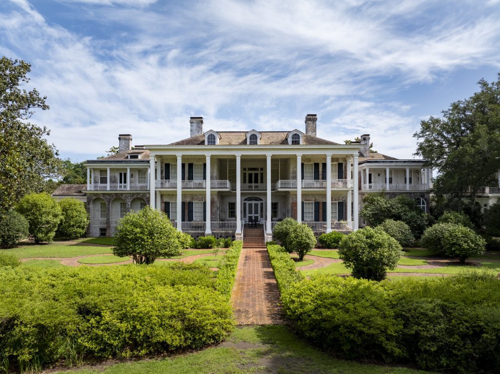 pebble-hill-plantation pebble-hill-plantation-house-green-bushes-lining-path-Thomasville-Georgia